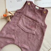 Close-up of dusty pink corduroy baby overalls with oversized front pocket